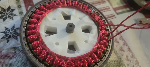 Hand-wound BLDC stator assembled around a white 3D-printed rotor carrier